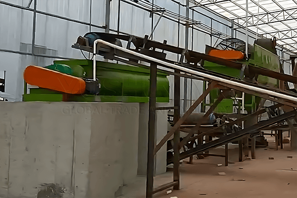 Fertilizer mixer with liquid spray system